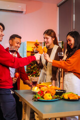 Lively Friday night New Year party with Asian friends, middle-aged and young adults, celebrating with champagne, wine, gifts, and food. A cozy, festive indoor gathering filled with joy and cheer.