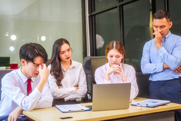 Two men and two women, including boss and employees, discuss recent mistake. Expressions of...