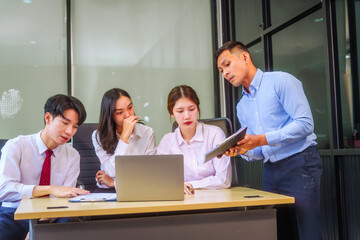 Two men and two women, including boss and employees, discuss recent mistake. Expressions of...