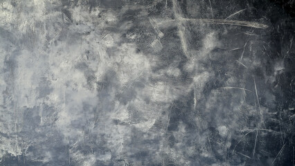 A large, dark gray canvas with a textured surface that resembles concrete or stone. The background is painted in shades of gray and white to create an industrial look.