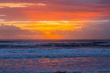 Fototapeta premium Colourful sunset skies over ocean waves. Gold Coast, Australia