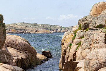scissor islands off sm&ouml;gen in sweden, with bright sunshine and small white clouds