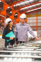 A female expertise engineering manager or inspector and Mechanic or technician are checking or examining the quality of metal sheet machine of industry, manufacturing or factory, Business successful.