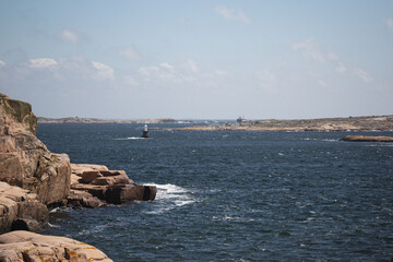 scissor islands off sm&ouml;gen in sweden, with bright sunshine and small white clouds