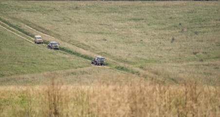 a pair of British army bae systems, Puch, Daimler, Pinzgauer High-Mobility All-Terrain 6x6 vehicles towing a 105mm Light Artillery Guns on a military exercise © Martin