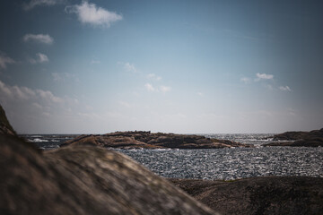 scissor islands off sm&ouml;gen in sweden, with bright sunshine and small white clouds