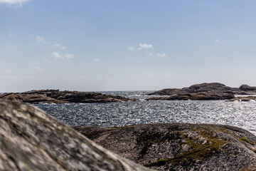 scissor islands off sm&ouml;gen in sweden, with bright sunshine and small white clouds