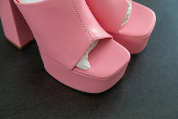 High heels with block heel and platform 90s mules in pink on an anthracite table