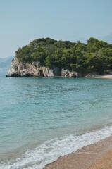 Naklejka premium view from a private beach of rocks with trees and the Adriatic Sea in Montenegro