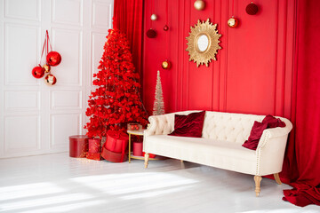 Cozy festive living room decorated with a red Christmas tree and elegant accents