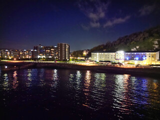 Obraz premium High Angle Night View of Dover Coastal City of South Eastern County of Kent England, United Kingdom. The Illuminated Footage Was Captured with Drone's Camera after Sunset Night of April 20th, 2024