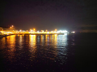 Naklejka premium High Angle Night View of Dover Coastal City of South Eastern County of Kent England, United Kingdom. The Illuminated Footage Was Captured with Drone's Camera after Sunset Night of April 20th, 2024