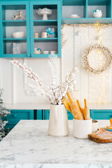 Bright and festive kitchen decor featuring winter arrangements and baking tools
