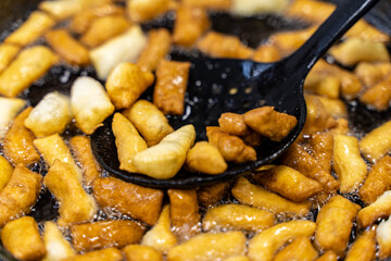 The dough is fried in pieces in a pan in oil (Pa Thong Ko), Baursaks or chak chak is a traditional national dish.