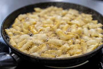 The dough is fried in pieces in a pan in oil (Pa Thong Ko), Baursaks or chak chak is a traditional national dish.