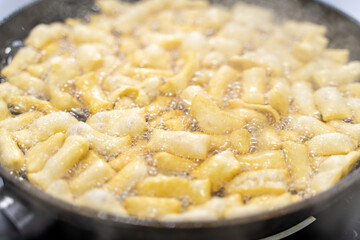 The dough is fried in pieces in a pan in oil (Pa Thong Ko), Baursaks or chak chak is a traditional national dish.