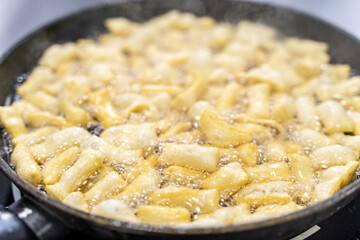 The dough is fried in pieces in a pan in oil (Pa Thong Ko), Baursaks or chak chak is a traditional national dish.