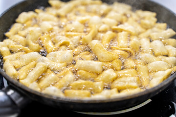 The dough is fried in pieces in a pan in oil (Pa Thong Ko), Baursaks or chak chak is a traditional national dish.