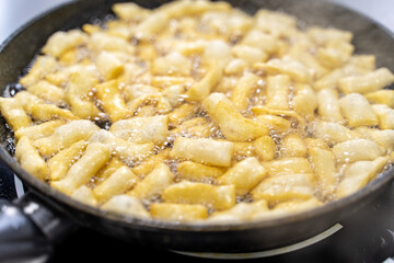 The dough is fried in pieces in a pan in oil (Pa Thong Ko), Baursaks or chak chak is a traditional national dish.
