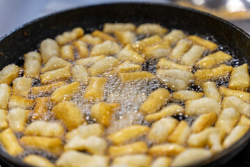 The dough is fried in pieces in a pan in oil (Pa Thong Ko), Baursaks or chak chak is a traditional national dish.