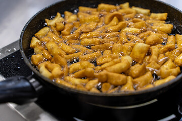 The dough is fried in pieces in a pan in oil (Pa Thong Ko), Baursaks or chak chak is a traditional national dish.