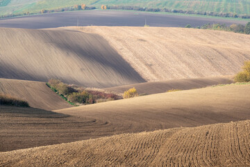 Stunning undulating arable agricultural landscape, photographed in autumn in south Moravia in the Czech Republic. The area is known as Moravian Tuscany and is full of rolling hills used for farming.