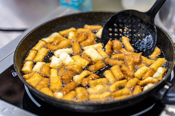 The dough is fried in pieces in a pan in oil (Pa Thong Ko), Baursaks or chak chak is a traditional national dish.