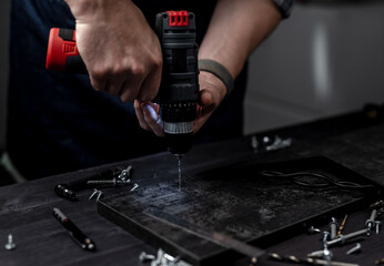 Master Drills Hole With Drill In Hands Close Up