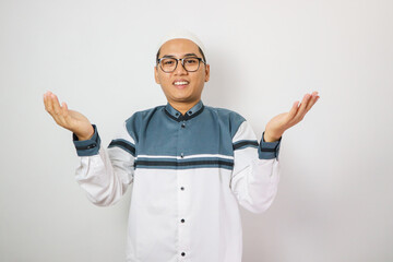 Moslem Asian man smiling at the camera with arms open doing welcoming gesture