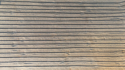Brown earth top view. Striped pattern of ploughed farmland soil. top view aerial shot top down