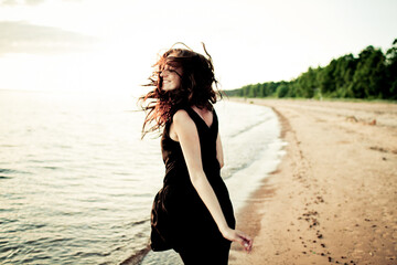 Woman Joyfully Running on the Beach at Sunset