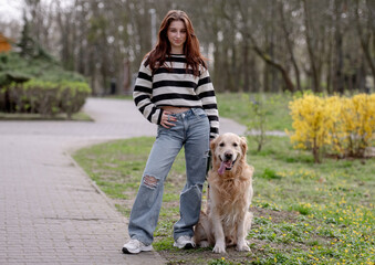 Teenage Girl Enjoys Spring Park With Golden Retriever