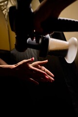 Naklejka premium A woman is getting an airbrush tan applied in a tent booth for a flawless look and glow