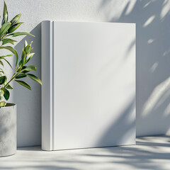 Minimalistic open empty, black book mockup, template with light shadows and branch element in a clean, white setting. Copy space for text.