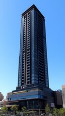 Obraz premium Modern Building Against a Blue Sky - Architectural Design Highlighting Urban Landscape and Cloudy Background