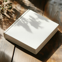 Fototapeta premium White Blank book cover mockup template for your book cover design, hardcover mock up of top view empty book on wooden desk.