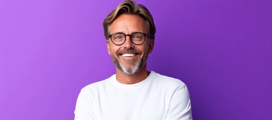 Fototapeta premium Man with glasses is smiling and posing for a picture. The image has a happy and friendly mood