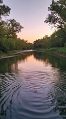 Obraz premium A tranquil view of the Kaw River at dusk showcases the calming reflection of trees and the soft hues of the evening sky
