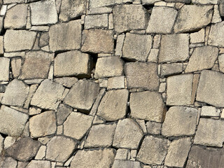 Close-up view of an ancient stone wall showcasing the texture and intricate masonry patterns
