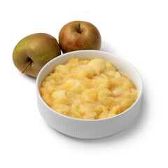 Ceramic bowl with organic homemade apple compote and fresh Bell de Boskoop apples isolated on white background close up  