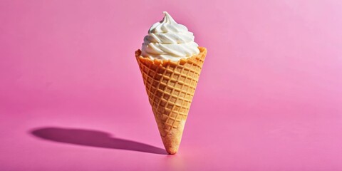 A Single Soft Serve Ice Cream Cone with a Crispy Waffle Conical Shell Stands Upright Against a Delicate Pink Background