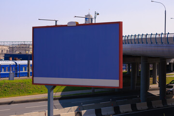 Advertising billboard along the road in the city on a winter day. Background for design. 