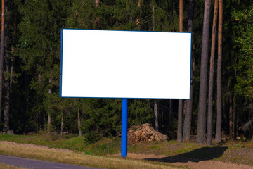 Fototapeta premium White billboard along the highway. Background for design and advertising. 