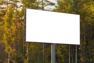 Advertising billboard along the road in the city on a sunny day. Background for design.