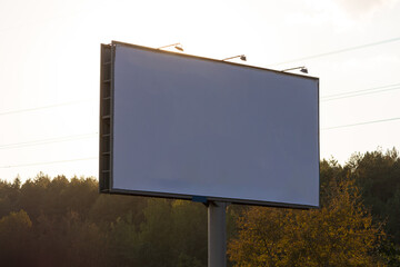 Advertising billboard along the road in the city on a winter day. Background for design. 