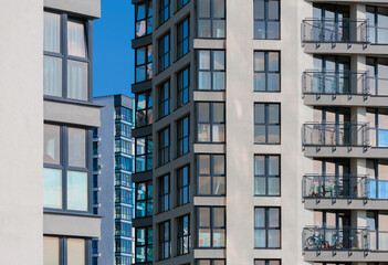 City view on a sunny day. Modern buildings, walls and windows. 