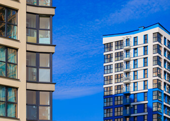 Modern buildings, walls and windows. City view on a sunny day. 