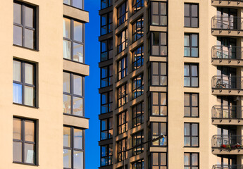 Modern buildings, walls and windows. City view on a sunny day. 