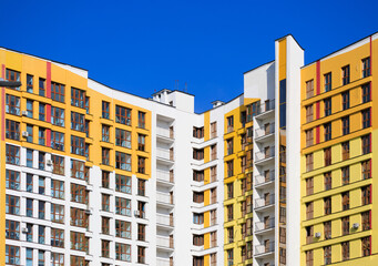 Fototapeta premium Modern buildings, walls and windows. City view on a sunny day. 