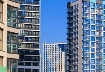 Obraz premium City view, modern buildings and skyscrapers against the blue sky.